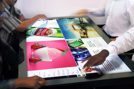 Hands browsing a digital menu on a touchscreen table